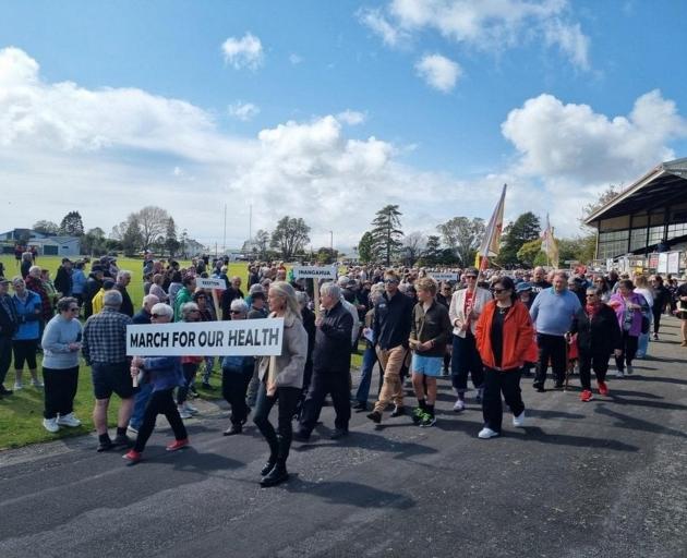 People march in Westport on Saturday, protesting cuts to after-hours GPs on the West Coast. PHOTO...