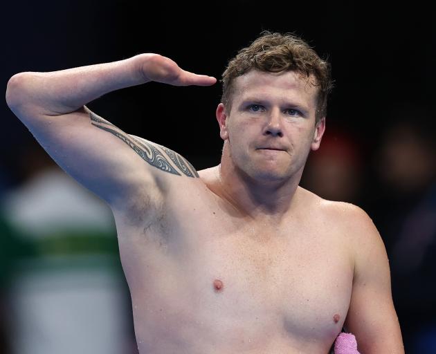 New Zealand swimmer Cameron Leslie salutes after finishing fourth in the final of the men’s 50m...