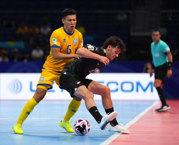 New Zealand’s Jordan Ditfort tries to hold off Kazakhstan defender Abdirassil Abdumanapuly during...