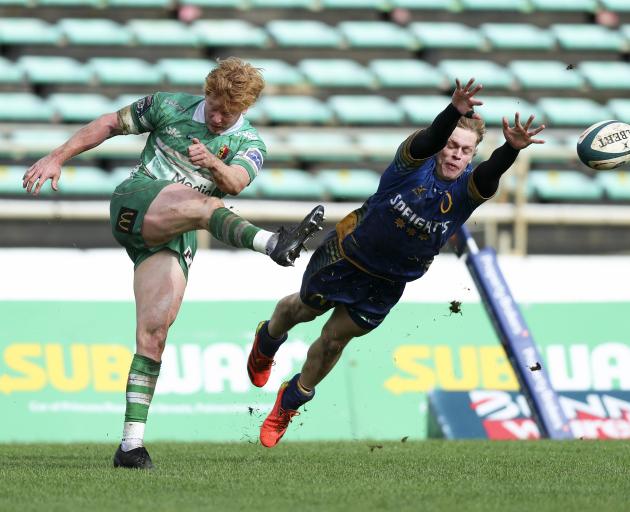 Reece MacDonald of Manawatū evades the challenge of Otago's Finn Hurley. Photo: Getty Images