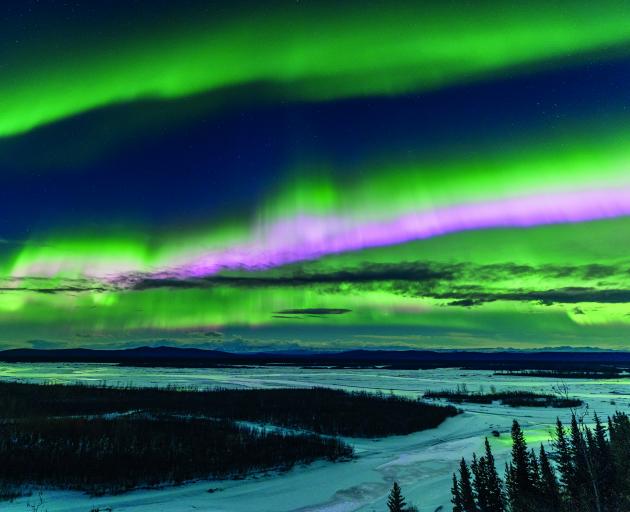 Aurora borealis over snowcapped mountains against the sky at night, in Fairbanks, Alaska. PHOTO:...