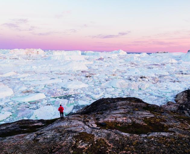A tourist looks out over the ice.