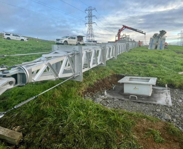 A temporary tower lies on a farm in Northland on 21 June 2024 as Transpower crews prepare to...