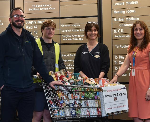 Helping lead a canned food drive at Dunedin Hospital are (from left) WellSouth dietitian Branko...