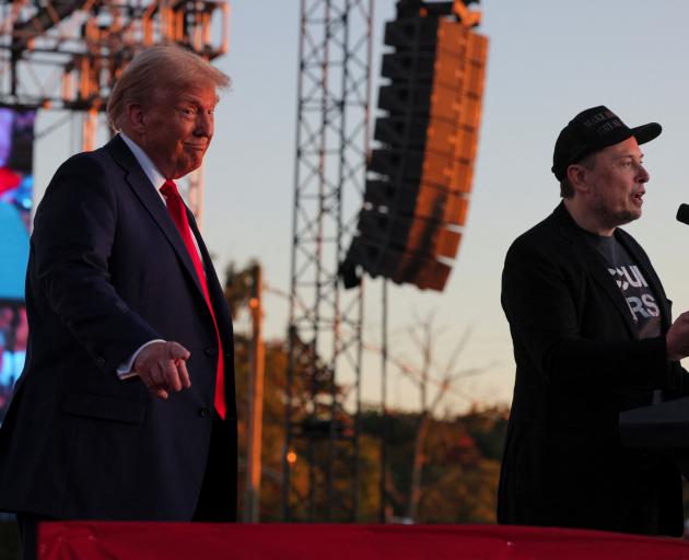 Tesla CEO and X owner Elon Musk speaks next to Republican presidential nominee and former US...