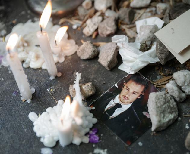 A picture of Liam Payne next to lit candles outside the hotel where the former One Direction band...