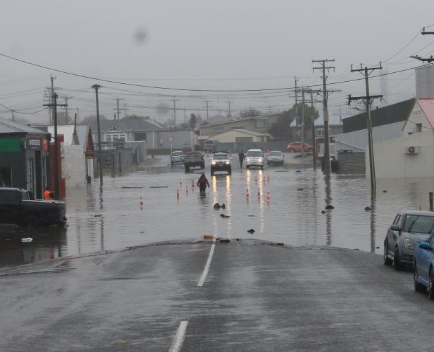 People were wading through water to get to their cars in Balclutha during yesterday's flooding....