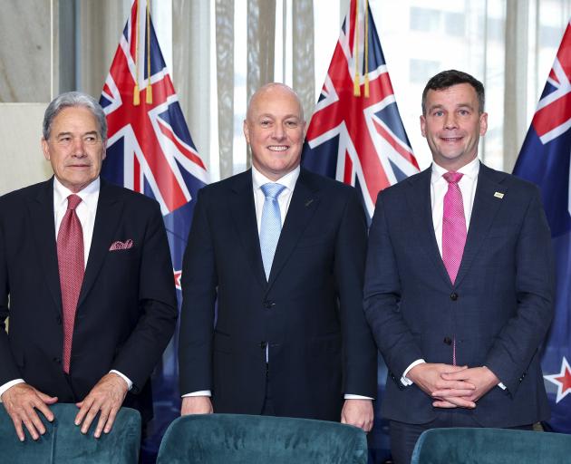 Winston Peters, Christopher Luxon, and David Seymour stand together after coming into power as a...