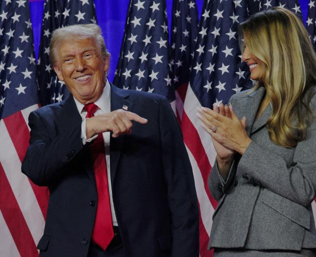 Republican Donald Trump shares a light-hearted moment with wife Melania at the Palm Beach County...