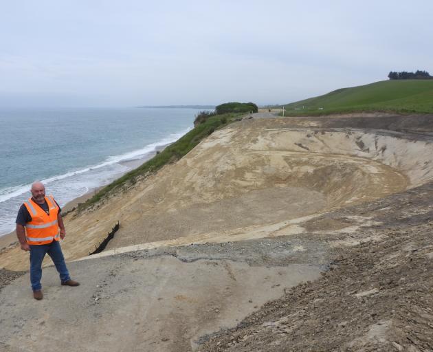 Waitaki District Council solid waste manager Steve Clark stands at the edge of the largest hole...