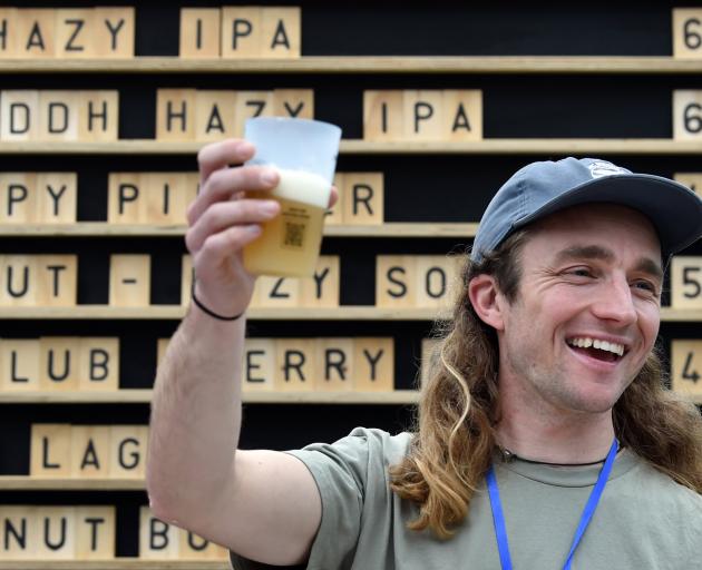 Sam Post, of Arc Brewing Co, serves a beer to thirsty customers.