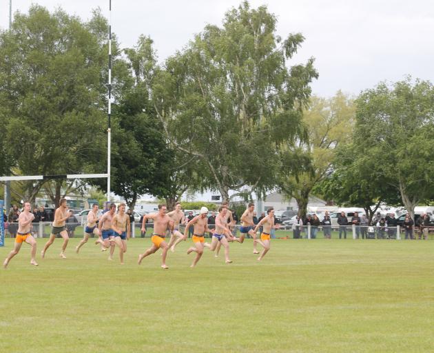 Competitors at the halftime undie run give it their absolute all, ending in a photo finish. PHOTO...