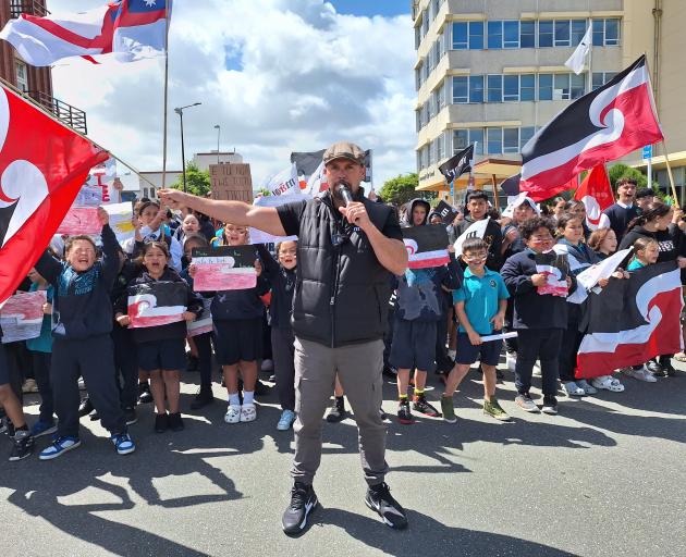 Te Pāti Māori MP Tākuta Ferris waves the Māori flag as he leads marchers outside the Invercargill...