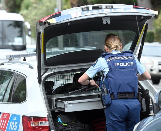 A police officer returns her weapon to a patrol car following an incident in Crown St, North East...