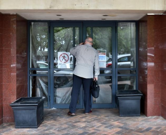 Sneak peek ... A member of the public peers through the window of the former Nova Cafe site, at...