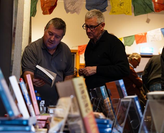 Wānaka Paper Plus general manager Chris Lumsden (left) talks to a customer at the New Zealand...