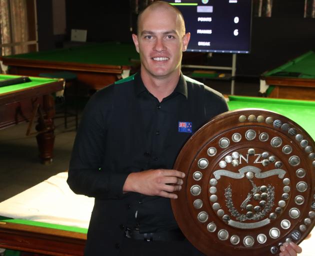 Shannon Swain, in 2022, holding the trophy for winning the New Zealand Billiards and Snooker...