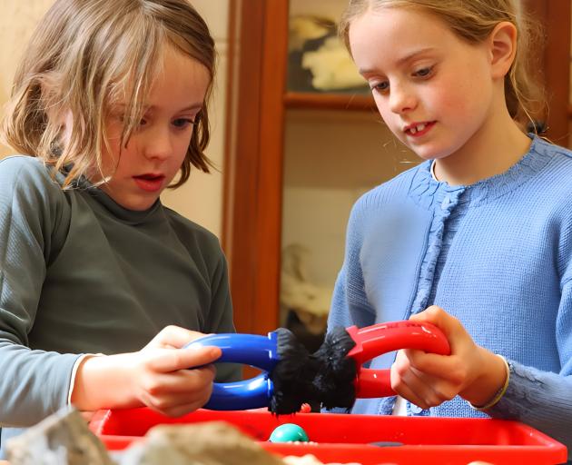 Investigating the properties of magnetic sand are Leonardo Reid, 7, and sister Clara, 9. PHOTOS:...