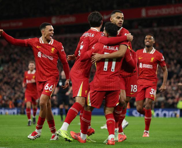 Liverpool celebrate scoring against Manchester City this morning. Photo: Reuters