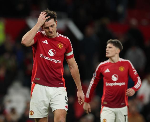 Manchester United's Harry Maguire and Alejandro Garnacho react following their loss to Newcastle...