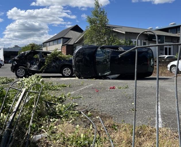An accident at the Hamilton Radiology carpark left the car resting on its side. Photo: RNZ /...