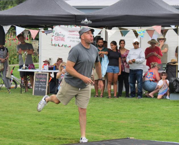 Chris McIlwrick spits the winning cherry pip 11.17m. PHOTOS: ELLA JENKINS