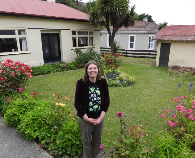 Chloe Searle in front of Janet Frame House. The garage (at right) is to be replaced by a visitor...