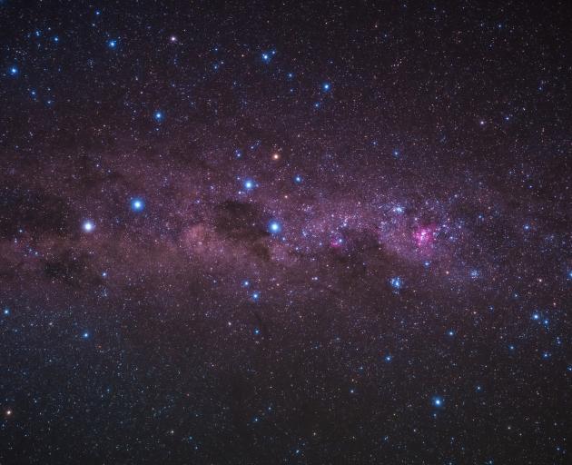 A spiral of stars representing the Milky Way galaxy with a bright clump in the middle at the...