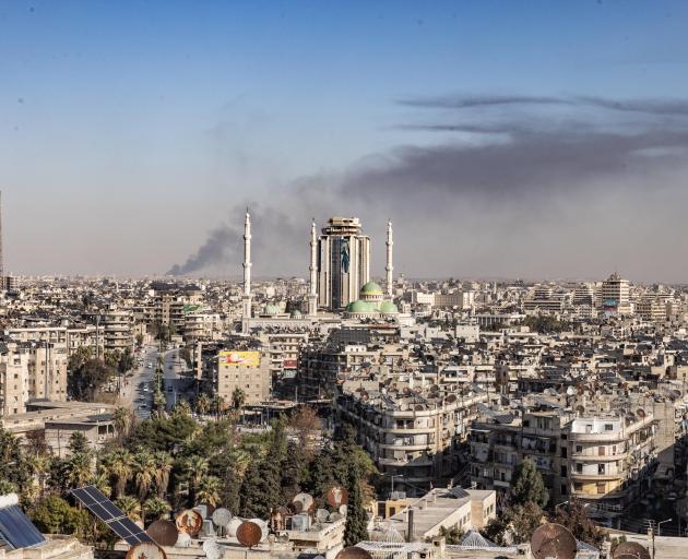 Smoke rises as a result of military operations in the city of Aleppo. The Syrian government has...