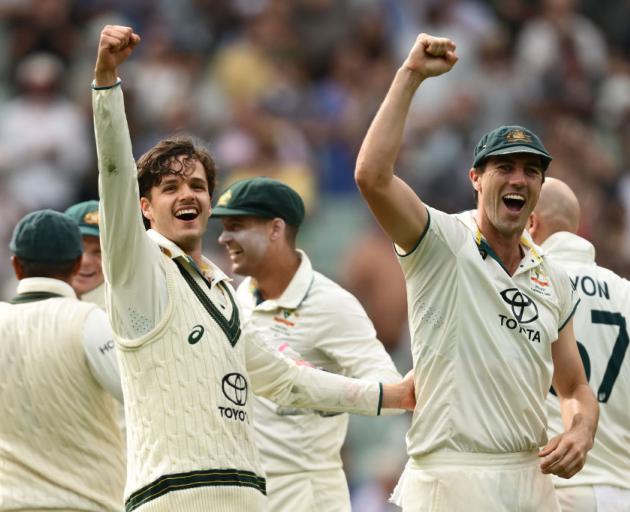 Debutant Sam Konstas (left) and captain Pat Cummins celebrate Australia's victory over India at...