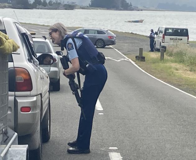 Armed police at a checkpoint at Te Ngaru, near Aramoana, this morning. Photo: Stephen Jaquiery