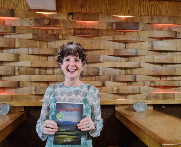 Wānaka writer L A Joye (Lauren Sleeman) with her new book, Wrongdoings. PHOTO: KATE GORDON SMITH 