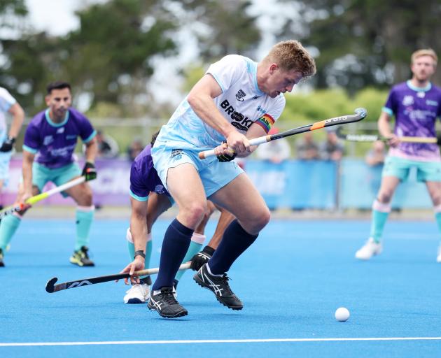 Alpiners striker Sam Lane prepares to pass the ball during a Premier Hockey League match against...