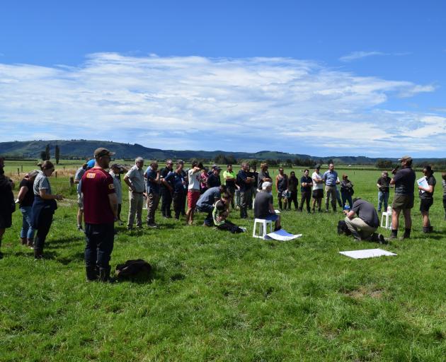 A group of people listen to sharemilker Cameron Edgecombe speak about his experience using Halter...