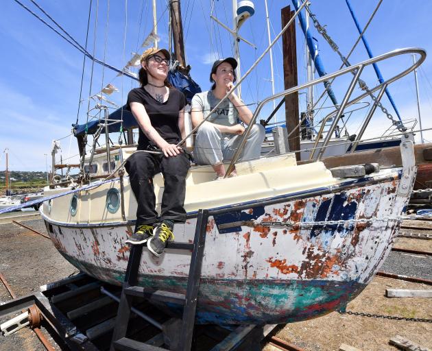 First-time boat builders Evelyn Virens (left) and Charlotte Goodyear sit on their new restoration...