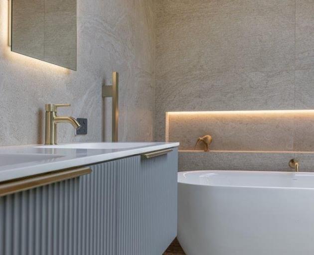 Floating vanities and creative lighting are on trend in bathrooms. This one was designed by...