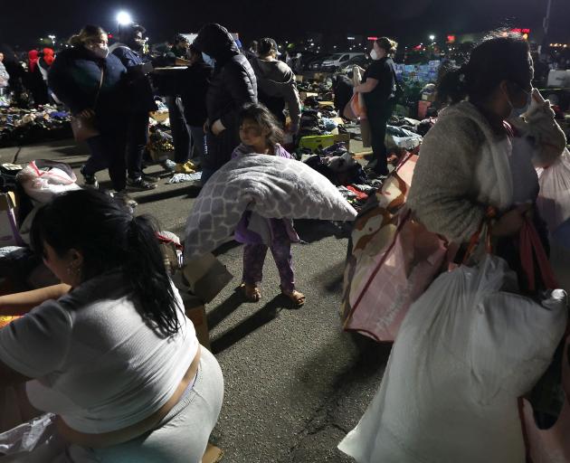 Families affected by the Eaton Fire pick up supplies and clothing at a distribution centre at...