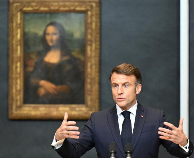 President Emmanuel Macron in front of the Louvre's prize attraction, the Mona Lisa. Photo: Reuters 