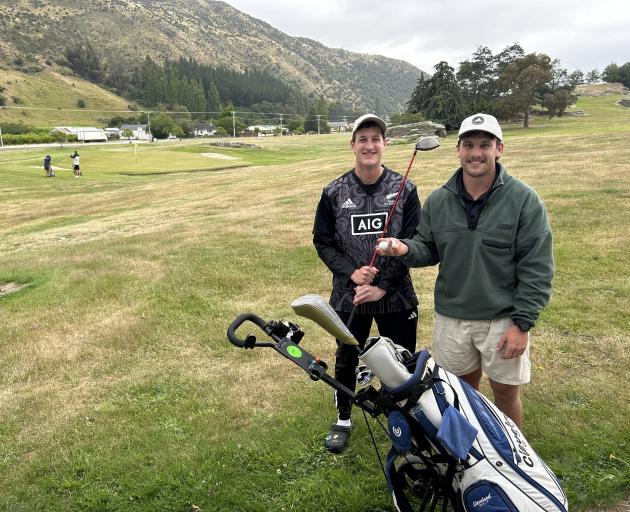 Dunedin sportsmen Nick Parata (left) and Bob Martin take a break after half of the 72 holes they...