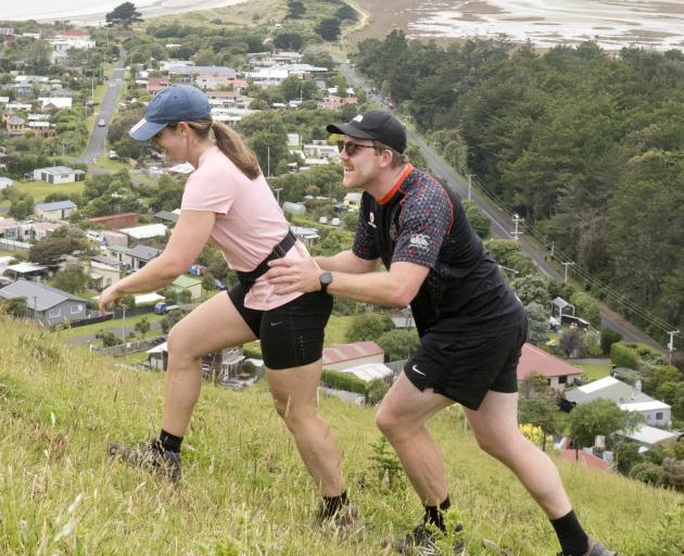 Kate Medder of Dunedin gets a push from her partner Joe Bywater up the Heyward Point track above...