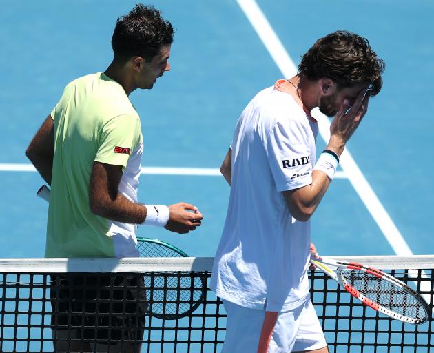 Cam Norrie (wearing white) cut a frustrated figure after getting knocked out of the ASB Classic...