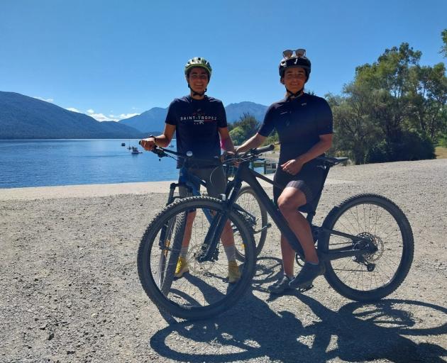 Olympian sailors Lara Granier, from France (left) and Sinem Kurtbay, from Finland, cycling in the...
