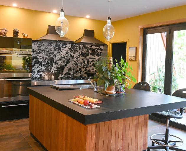 Large ceramic tiles serve as a backsplash in the kitchen.