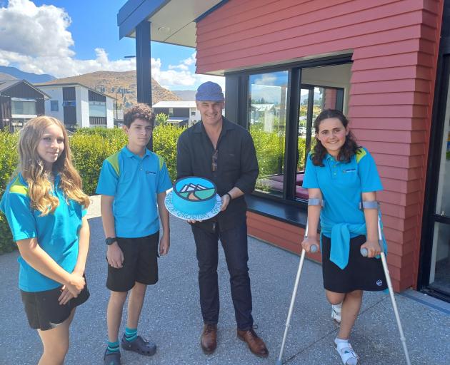 Fleur Dayman, Jake Wilkinson, both 12, principal Ben Witheford and Amelia Black, 12, with a cake...