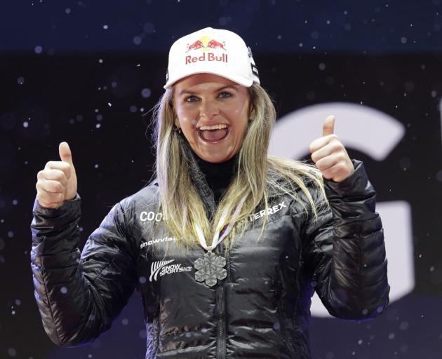 Alice Robinson celebrates on the podium with her silver medal from the women's giant slalom at...