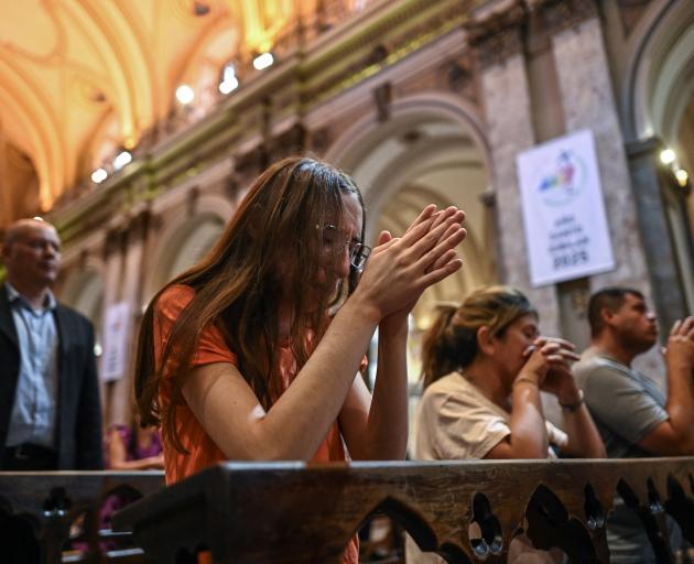 Catholic faithful attend a mass at the Metropolitan Cathedral in Buenos Aires to pray for Pope...