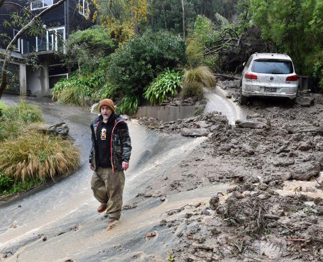 Shaun Campbell walks away from a landslip from above his neighbour’s house at Challis in...