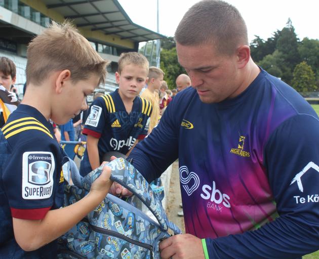 Highlanders fan Jossi Broad gets his backpack signed by Highlanders and All Blacks prop Ethan de...