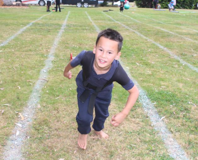 Mana Gilles, 8, drags a weighed-down sledge during the Pop Up Party in the Park.
