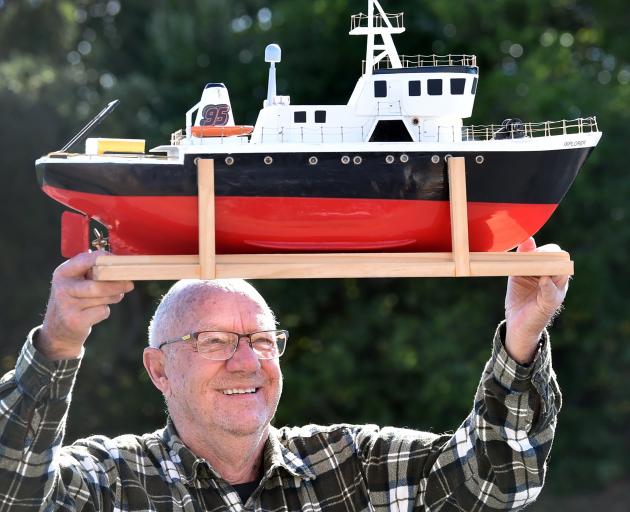 Kevin Gamble of Dunedin carries in his model boat for display at the Model Engineering Expo.